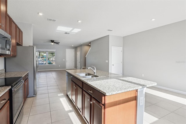 6013 Blue Lily Way, Winter Garden, FL 34787 - kitchen with stainless steel appliances, light tile patterned flooring, a kitchen island with sink, light stone counters, and recessed lighting