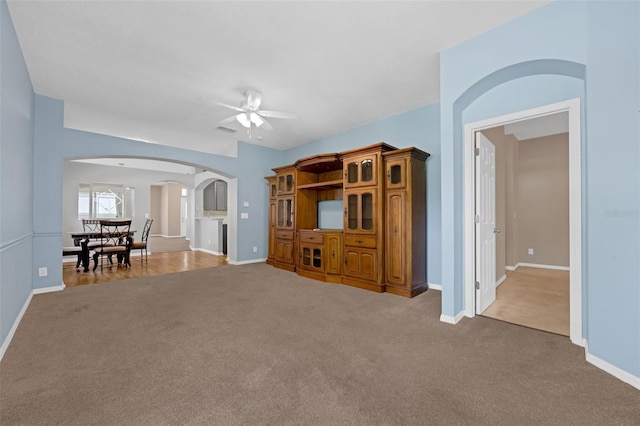 1868 Rachels Ridge Loop Unit L, Ocoee, FL 34761 - carpeted living room with arched walkways and a ceiling fan