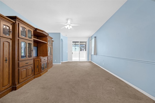 1868 Rachels Ridge Loop Unit L, Ocoee, FL 34761 - unfurnished living room featuring a ceiling fan, carpet, and arched walkways