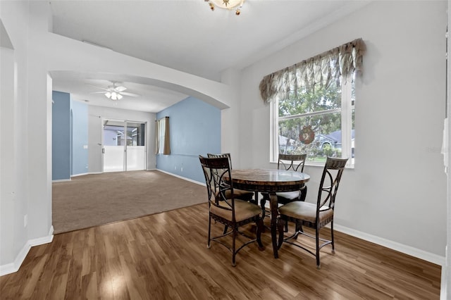 1868 Rachels Ridge Loop Unit L, Ocoee, FL 34761 - dining area featuring wood finished floors, arched walkways, ceiling fan, and plenty of natural light