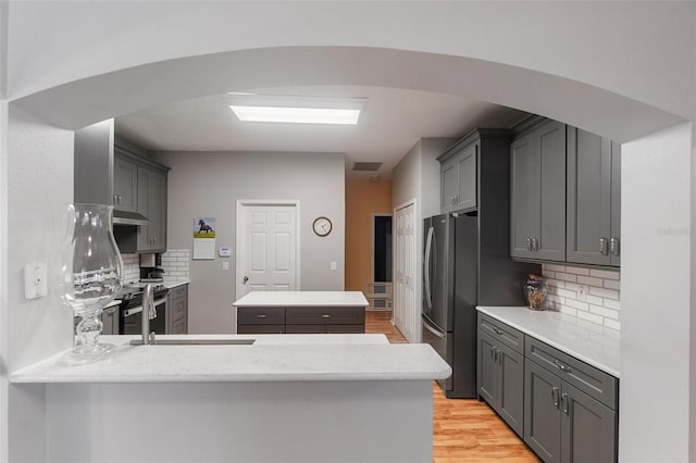 1868 Rachels Ridge Loop Unit L, Ocoee, FL 34761 - kitchen featuring freestanding refrigerator, under cabinet range hood, gray cabinets, and a peninsula
