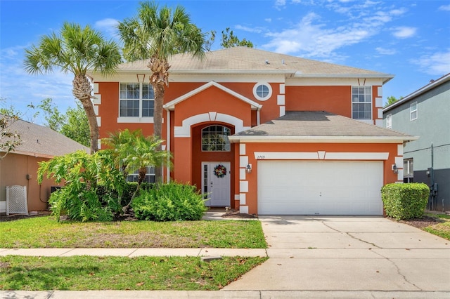 traditional home with a garage, stucco siding, and concrete driveway
