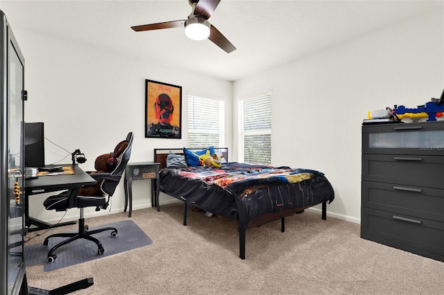 bedroom with ceiling fan, baseboards, and light colored carpet