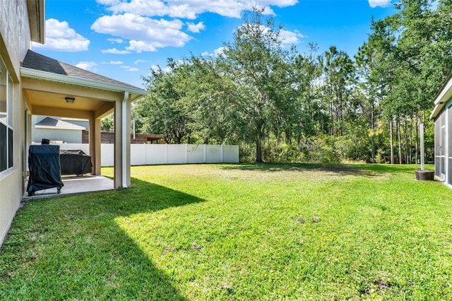 view of yard featuring a patio and fence