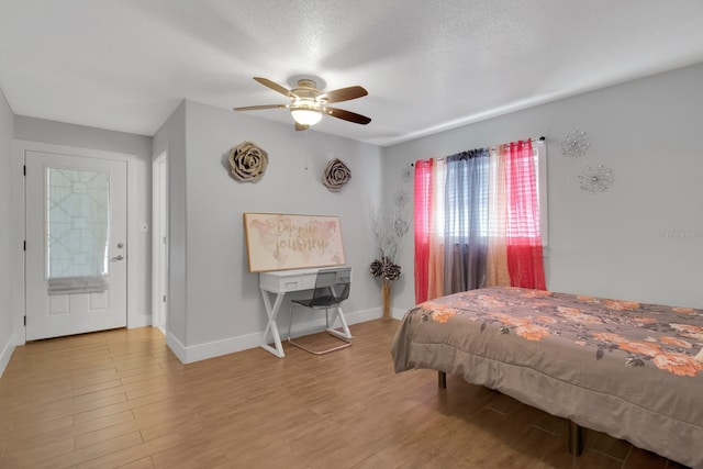 6464 Inca St, Orlando, FL 32807 - bedroom with multiple windows, wood finished floors, baseboards, and a ceiling fan