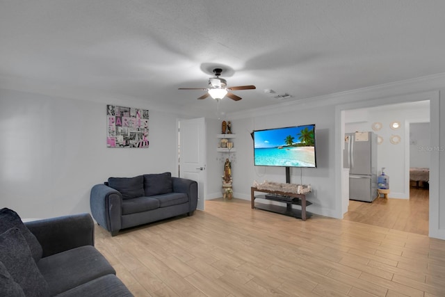 6464 Inca St, Orlando, FL 32807 - living room with ceiling fan, light wood finished floors, ornamental molding, and baseboards