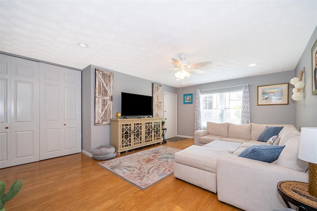 living area with baseboards, recessed lighting, wood finished floors, and ceiling fan