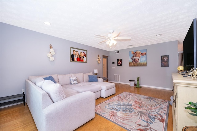 living area featuring visible vents, ceiling fan, recessed lighting, and light wood-style flooring