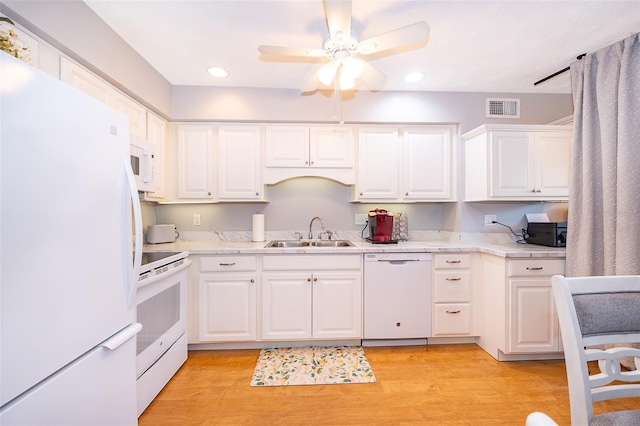 kitchen with a sink, ceiling fan, visible vents, white cabinetry, and white appliances