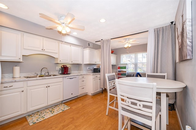 kitchen with white cabinetry, a sink, ceiling fan, white dishwasher, and light wood finished floors
