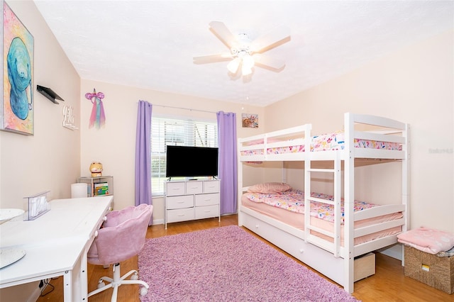 bedroom featuring wood finished floors and a ceiling fan