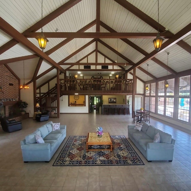 5325 Hansel Ave Unit E-15, Orlando, FL 32809 - tiled living room with high vaulted ceiling, stairway, beamed ceiling, and a chandelier