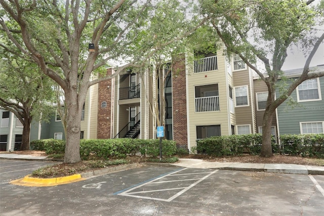 view of building exterior with uncovered parking