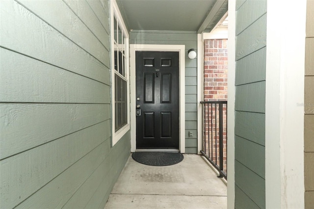 view of exterior entry featuring covered porch