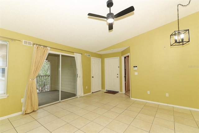 tiled spare room with visible vents, ceiling fan, vaulted ceiling, and baseboards