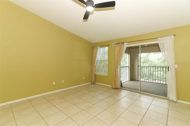spare room with baseboards, light tile patterned floors, and a ceiling fan