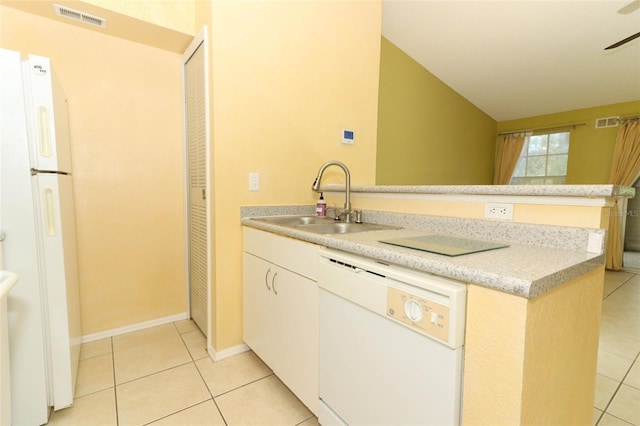 kitchen with visible vents, light tile patterned floors, white appliances, and a sink