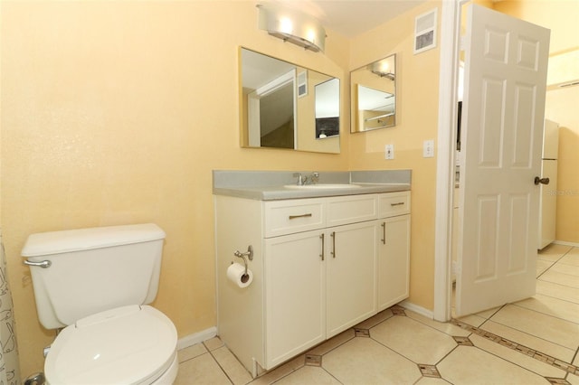 bathroom featuring tile patterned floors, toilet, vanity, baseboards, and visible vents