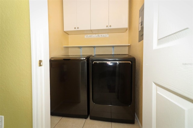 laundry area with light tile patterned flooring, separate washer and dryer, and cabinet space