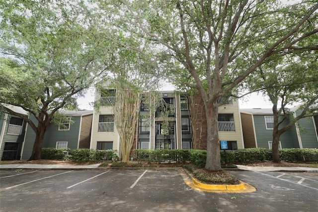 view of building exterior featuring uncovered parking