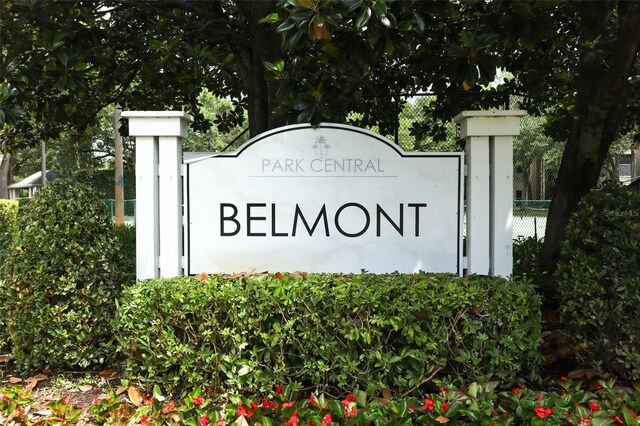 community / neighborhood sign with fence