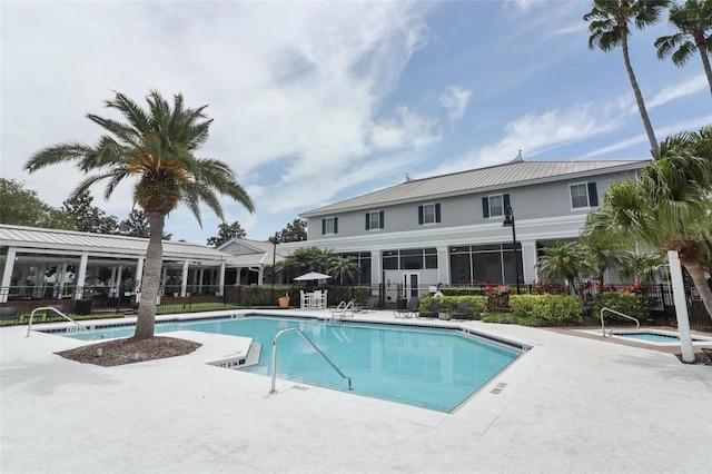 pool with fence and a patio area