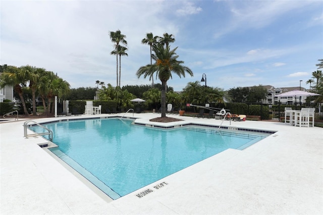 pool featuring a patio and fence
