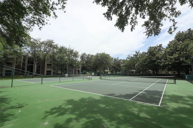 view of tennis court featuring fence