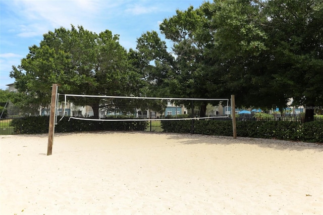 view of community with fence and volleyball court