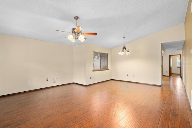 1105 Mill Run Cir, Apopka, FL 32703 - empty room featuring ceiling fan, wood-type flooring, a chandelier, baseboards, and a textured ceiling