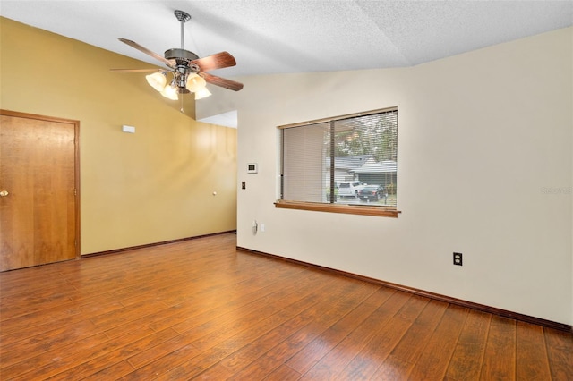 1105 Mill Run Cir, Apopka, FL 32703 - spare room featuring lofted ceiling, ceiling fan, hardwood / wood-style floors, baseboards, and a textured ceiling