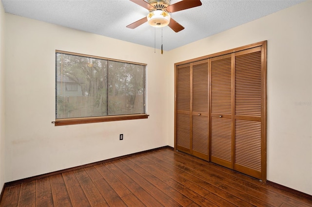 1105 Mill Run Cir, Apopka, FL 32703 - unfurnished bedroom featuring dark wood-type flooring, a closet, baseboards, a ceiling fan, and a textured ceiling