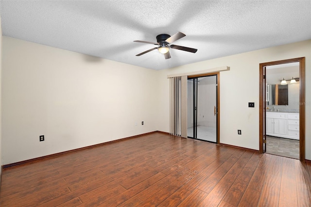 1105 Mill Run Cir, Apopka, FL 32703 - unfurnished bedroom with dark wood-style floors, baseboards, ceiling fan, a closet, and a textured ceiling