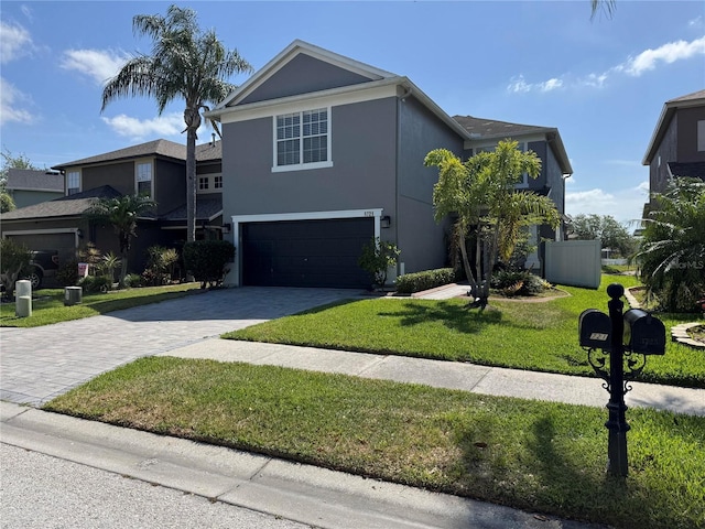 3721 Heron Island Dr, New Port Richey, FL 34655 - traditional home featuring stucco siding, decorative driveway, a front yard, and a garage