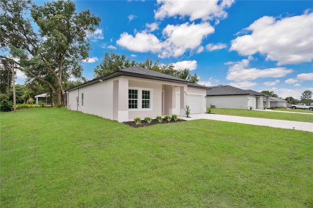 prairie-style home with an attached garage, driveway, a front yard, and stucco siding
