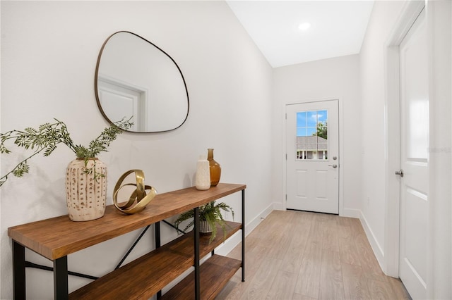 entryway featuring baseboards and light wood-style floors
