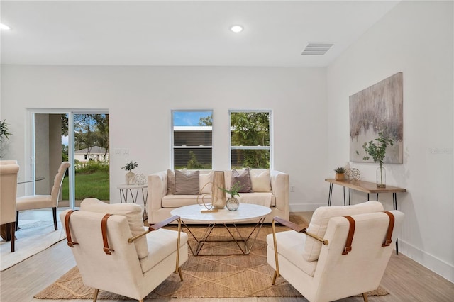 living room featuring recessed lighting, visible vents, and light wood-type flooring