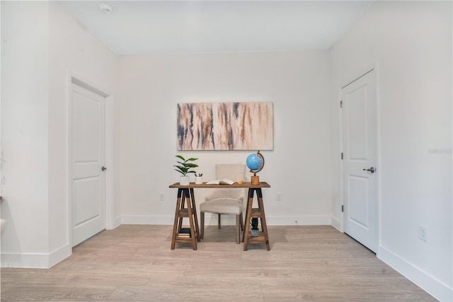 office area featuring light wood-style floors and baseboards
