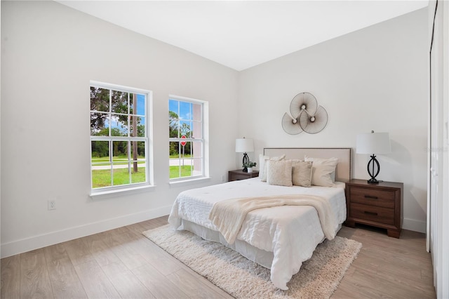 bedroom featuring baseboards and light wood-style floors
