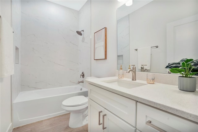 full bathroom with shower / bath combination, wood finished floors, toilet, and vanity