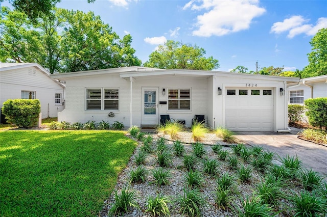 1424 W New Hampshire St, Orlando, FL 32804 - view of front of house featuring brick siding, a garage, driveway, and a front yard