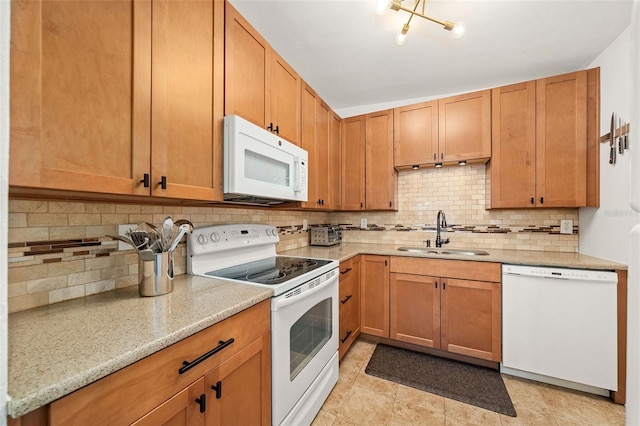 1424 W New Hampshire St, Orlando, FL 32804 - kitchen with light stone countertops, a sink, white appliances, and tasteful backsplash