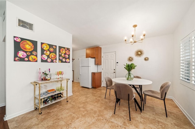 1424 W New Hampshire St, Orlando, FL 32804 - dining space featuring visible vents, baseboards, and a notable chandelier