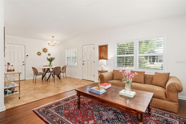 1424 W New Hampshire St, Orlando, FL 32804 - living room with an inviting chandelier, baseboards, and wood finished floors