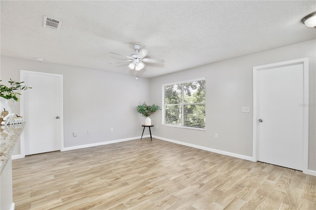 956 Salt Pond Pl Unit 207, Altamonte Springs, FL 32714 - empty room with a ceiling fan, light wood-style flooring, a textured ceiling, and baseboards