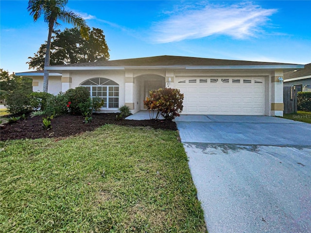 single story home featuring an attached garage, driveway, a front lawn, and stucco siding