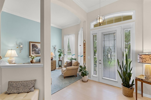entrance foyer with arched walkways, ornamental molding, and a healthy amount of sunlight