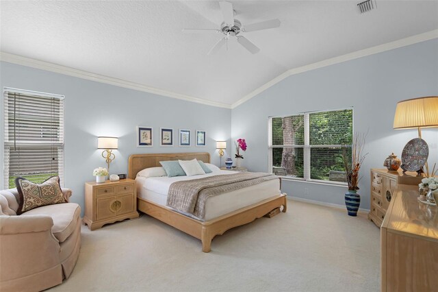 bedroom featuring lofted ceiling, visible vents, light colored carpet, and ornamental molding