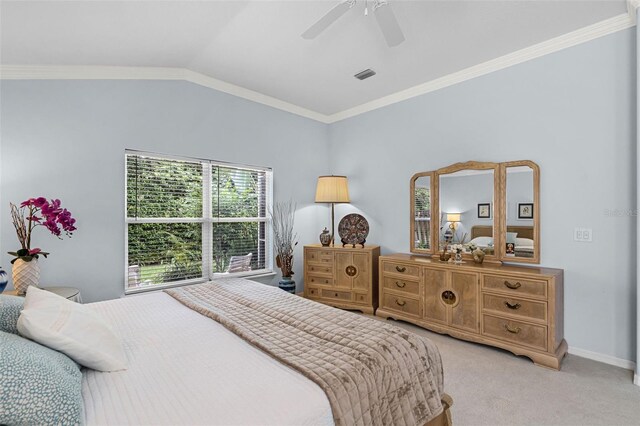 bedroom with vaulted ceiling, visible vents, light colored carpet, ceiling fan, and ornamental molding