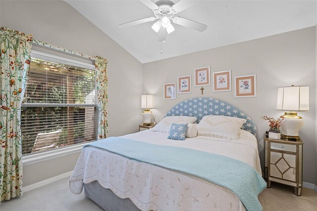 carpeted bedroom with vaulted ceiling, baseboards, and a ceiling fan